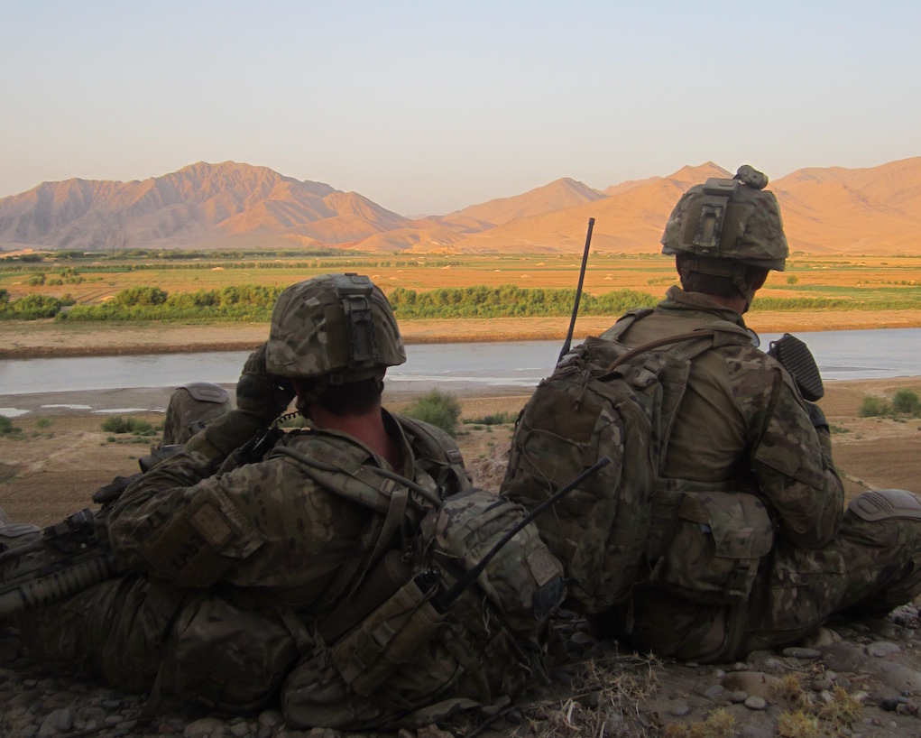 Soldiers overlooking mountain range.